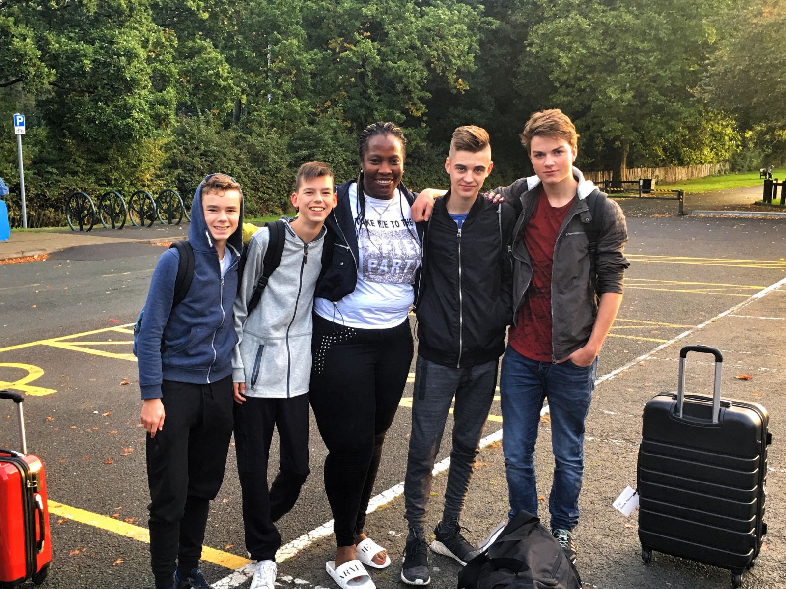 A Bromley host with students and their luggage at the Norman Park meeting point