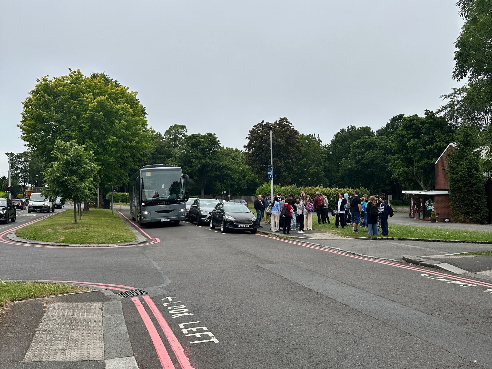 A coach and waiting students at the Shirley meeting point in West Wickham
