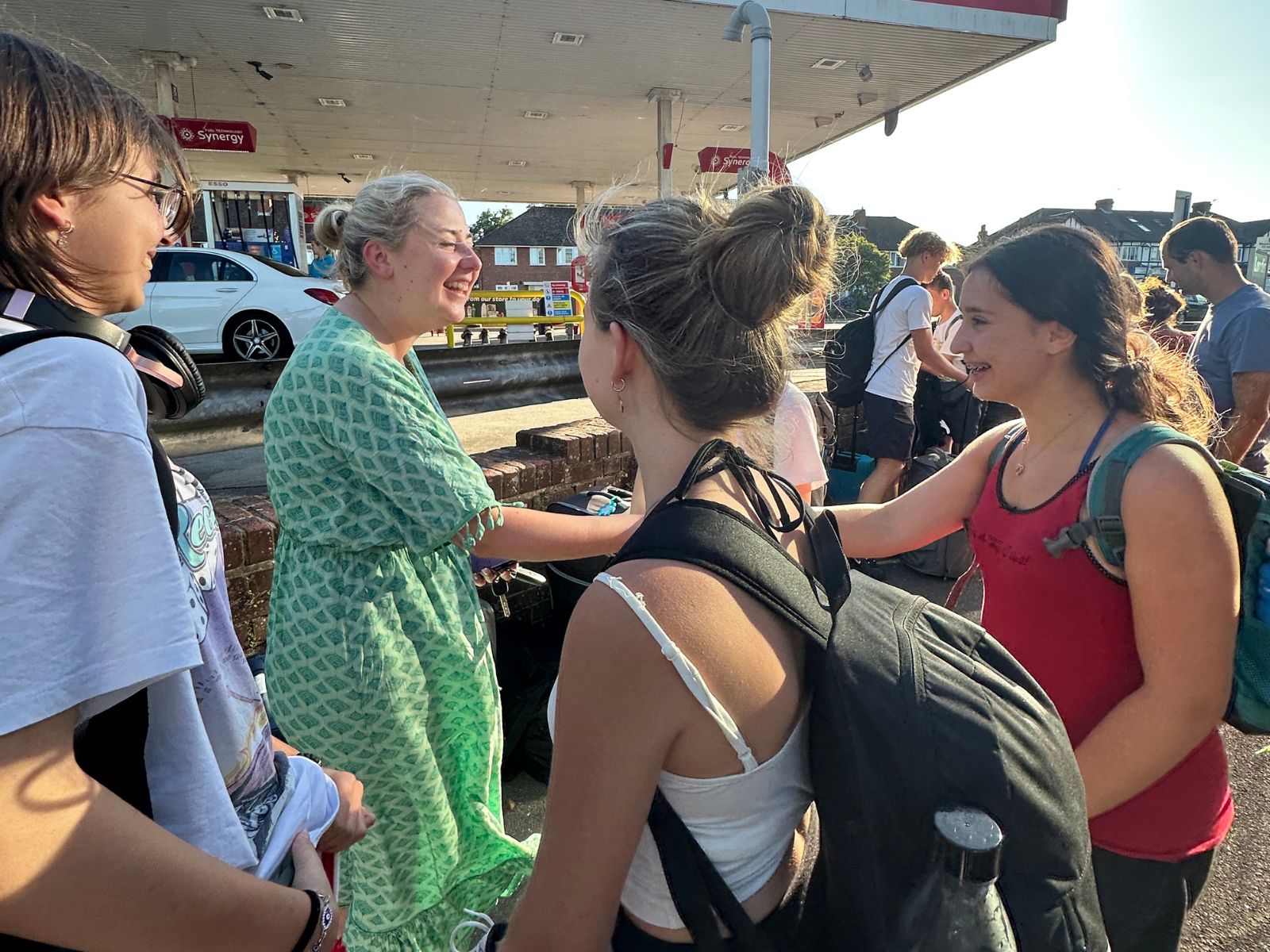 A host greeting students at the Beckenham meeting point